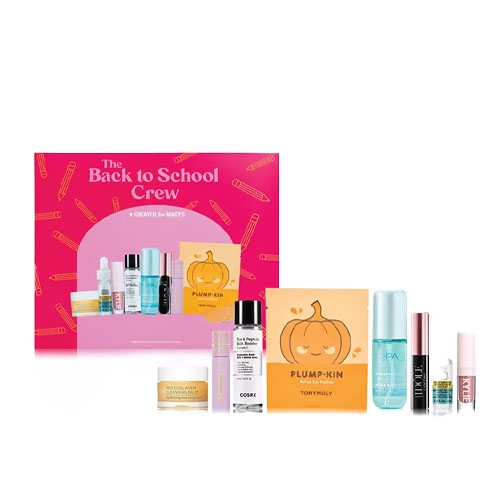 A Macy's \“Back to School Crew\“ beauty set is displayed, featuring a variety of skincare products including a pumpkin-themed mask, serums, sprays, and a lip product.